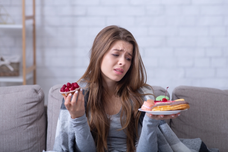 woman trying to eat food